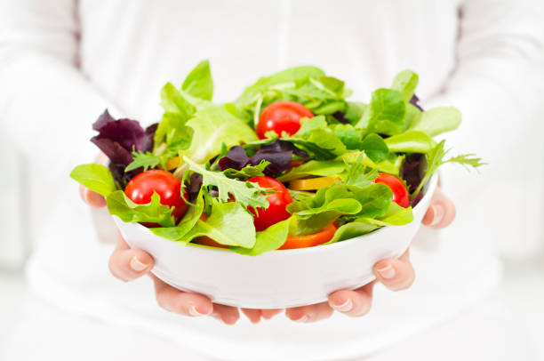istock Woman holding a salad bowl 171263591