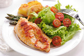 Grilled chicken steak with potatoes,asparagus and salad