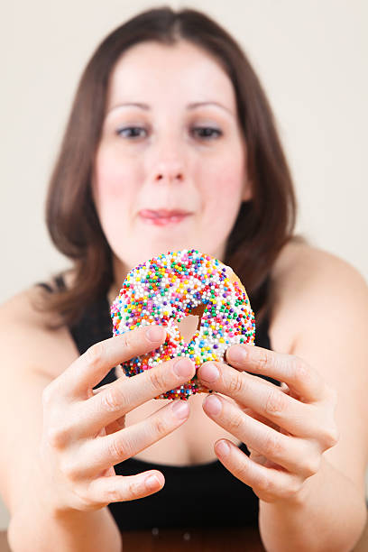istock Beautiful woman eating donut 171264088