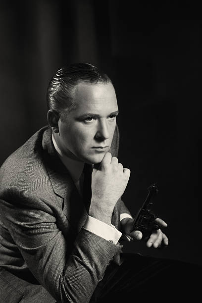 Old Hollywood. Man with the gun Emulation of vintage style photography.Grain added for more film effect.See the Lightbox: actor photos stock pictures, royalty-free photos & images