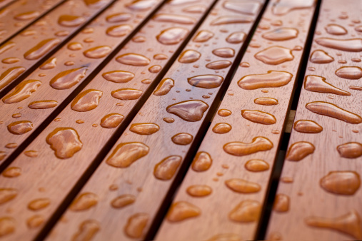 Water droplets on wood.