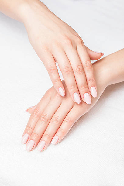 istock A woman's hands and pale painted nails on white towel 171264359