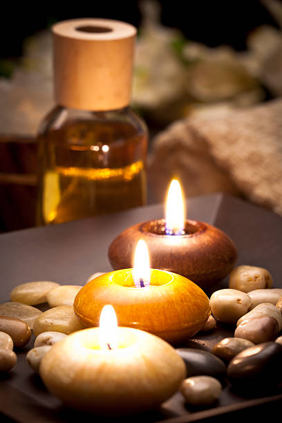 istock Aromatherapy candles in a row with relaxing stones 171264467