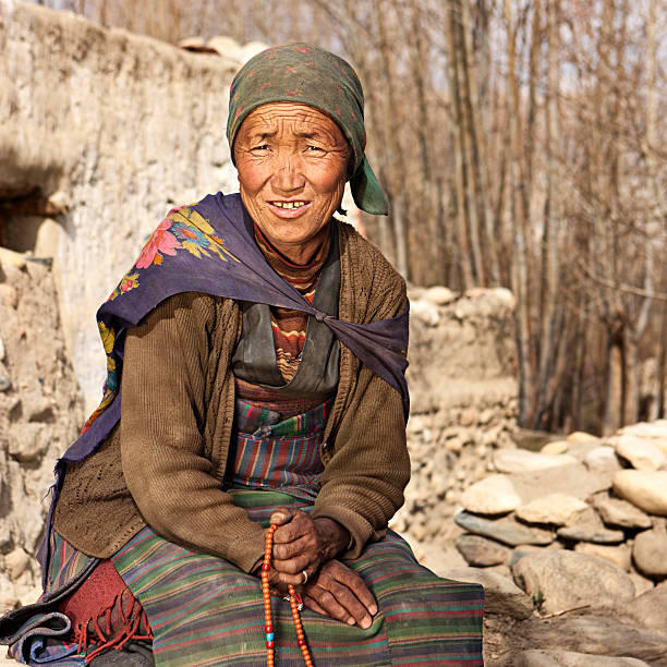 istock Tibetan woman praying with rosary. 171264523