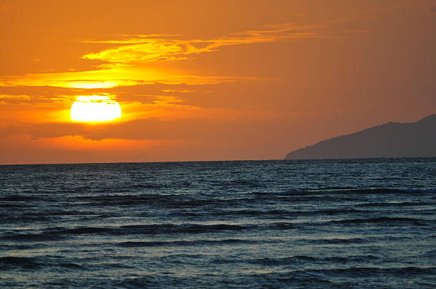 Beautiful silhouette sunset at tropical sea .