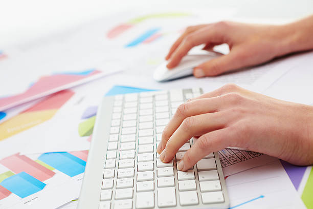 istock Woman typing on keybord with charts around her 171264792
