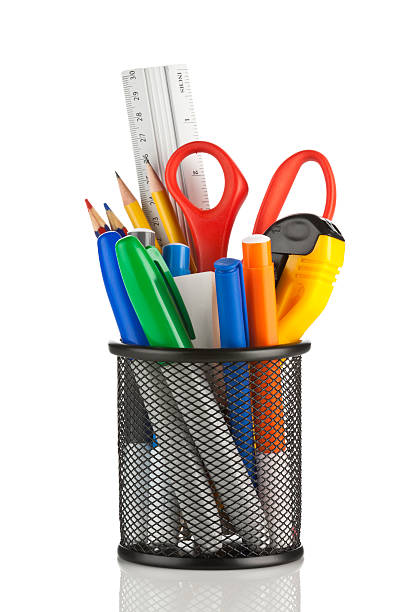 Desk organizer filled with some office supplies on white backdrop