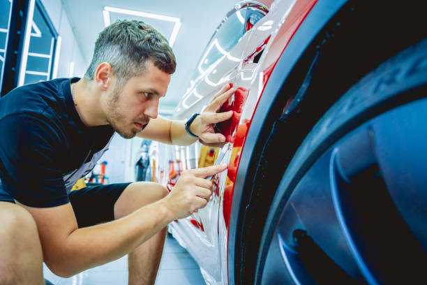 istock The process of installing protective film on the new red car. 1712653845