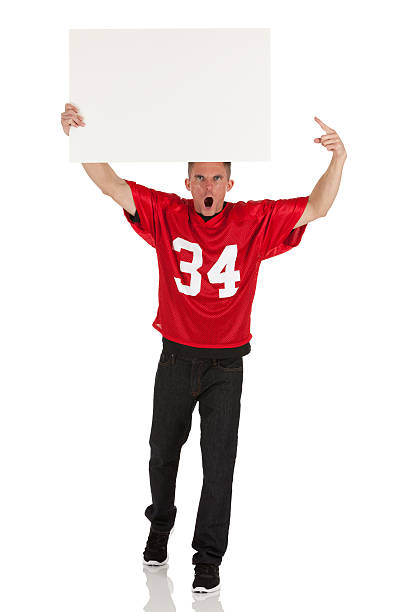 Sports fan holding a placard and shouting