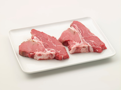Raw T-Bone Steak In A Plate