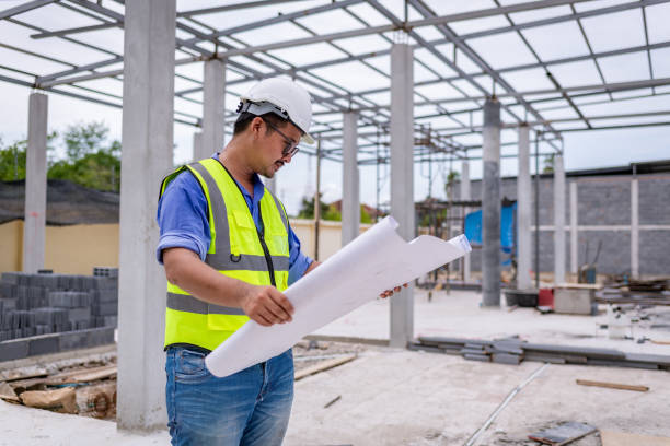 istock Architect engineer wearing safety uniform survey and working at structure building site blueprint check detail of work common work is engineer building architecture concept. 1712666379