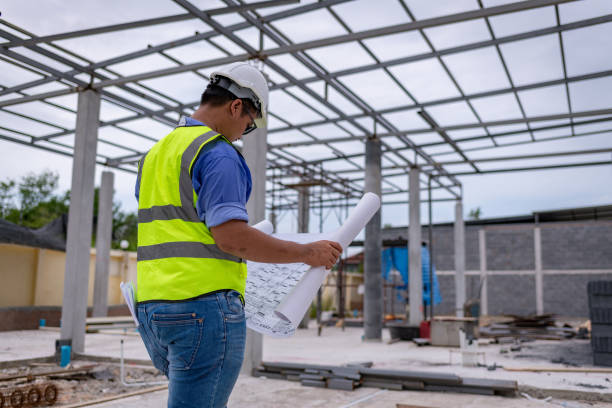 istock Architect engineer wearing safety uniform survey and working at structure building site blueprint check detail of work common work is engineer building architecture concept. 1712666903