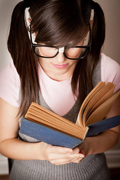 istock Close Up of Nerdy Young Woman Student Reading Book 171266892