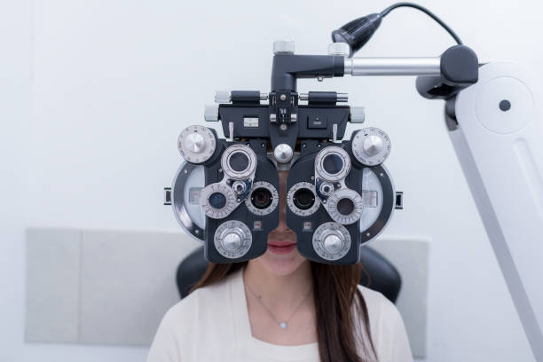 istock Woman optical shop customer doing eyesight measurement with optical phoropter check eye distance for eyeglasses is optical eye shop service. 1712669482