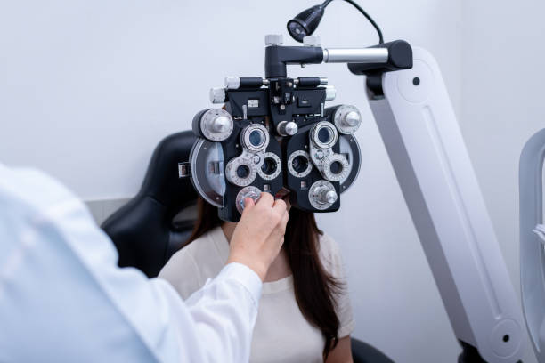 istock Woman optical shop customer doing eyesight measurement with optical phoropter check eye distance for eyeglasses is optical eye shop service. 1712670029