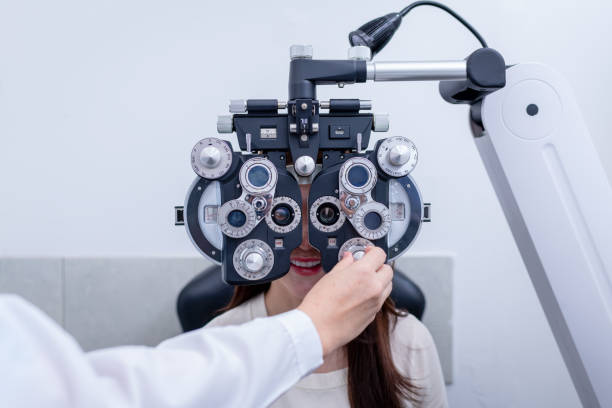 istock Woman optical shop customer doing eyesight measurement with optical phoropter check eye distance for eyeglasses is optical eye shop service. 1712670043