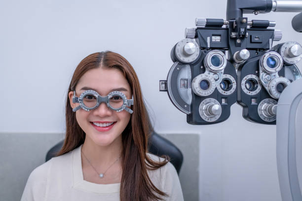 istock Woman optical shop customer doing eyesight measurement with optical phoropter check eye distance for eyeglasses is optical eye shop service. 1712670607