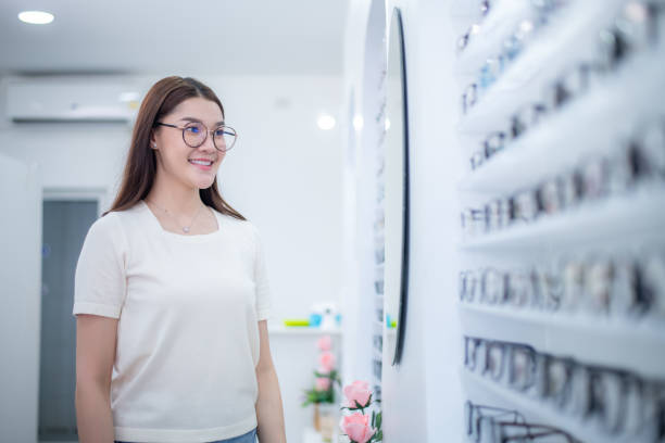 istock Woman optical shop customer doing eyesight measurement with optical phoropter check eye distance for eyeglasses is optical eye shop service. 1712671758