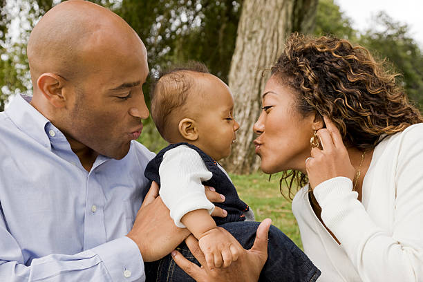 istock A mom and dad playing with their baby 171267275
