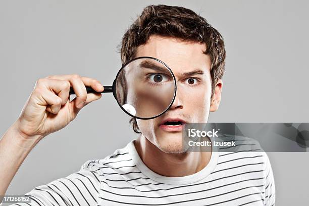 Man With Magnifying Glass Stock Photo - Download Image Now - Magnifying Glass, Holding, Loupe