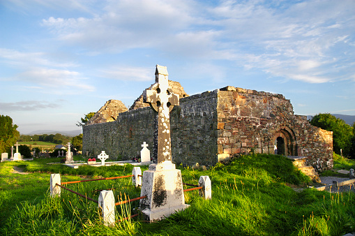 Wide angle view of a cemetery and church ruin in County Kerry, Ireland. Taken late in the evening just before sunset. Space for copy at top of image.