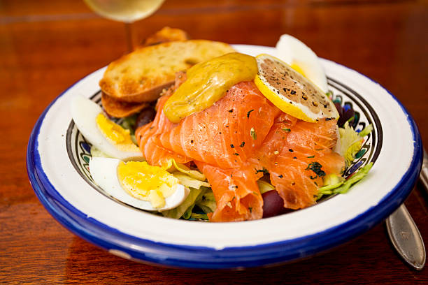 Salad with raw pickled salmon served on wooden table Salad with raw pickled salmon served on wooden tableSee also my LB: gravad stock pictures, royalty-free photos & images