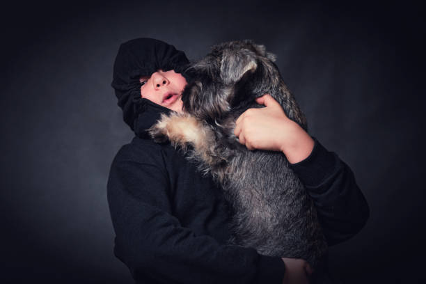 istock Child boy hugging his dog. Studio shot on a dark background. 1712684603
