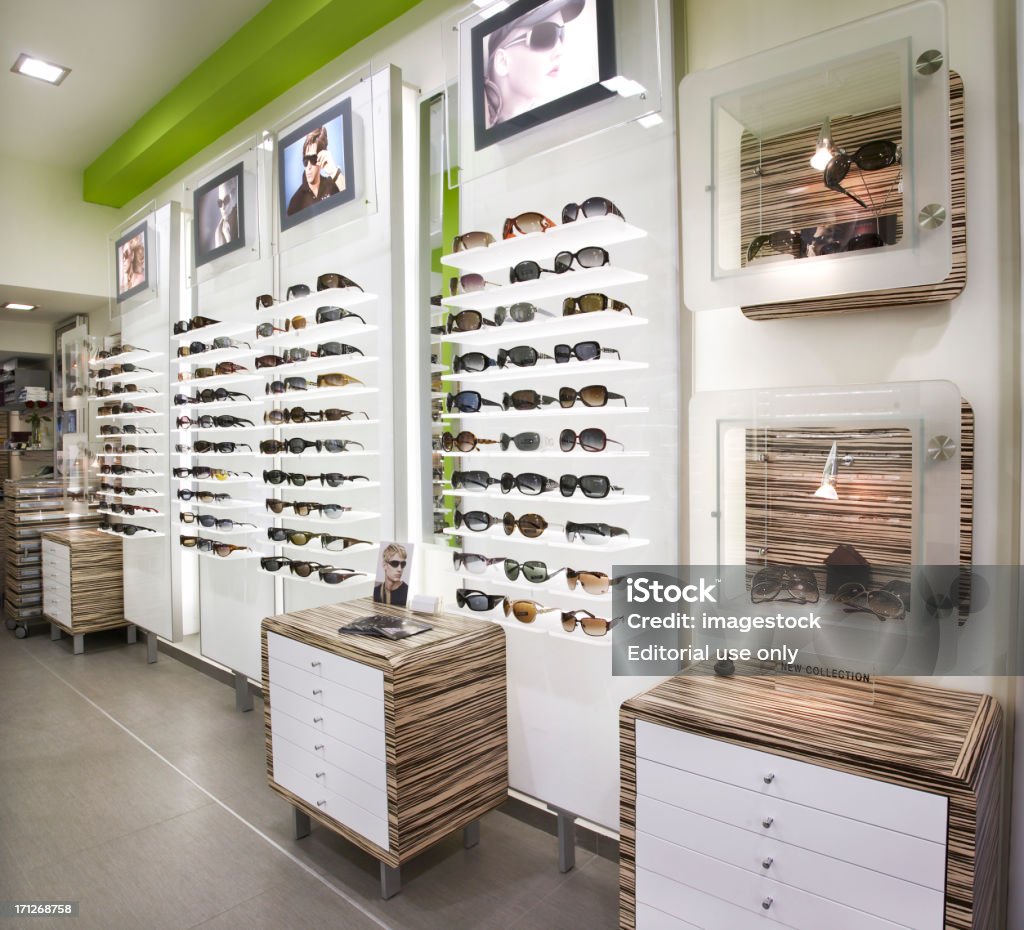 Optician’s shop "Athens, Greece - February 27, 2008: Photograph of an optician's shop in Athens. There are frames on both sides of the shop. The place has been shot in perspective." Optometrist Stock Photo