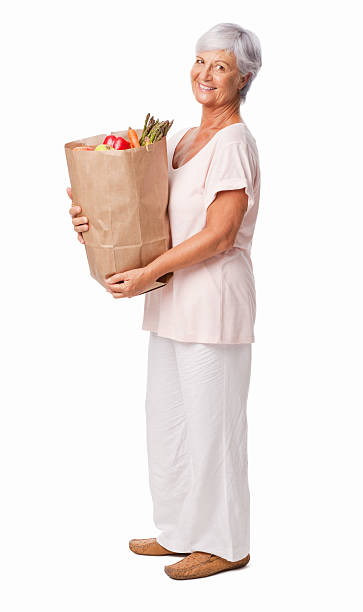 donna portare generi alimentari freschi isolati - senior adult aging process supermarket shopping foto e immagini stock