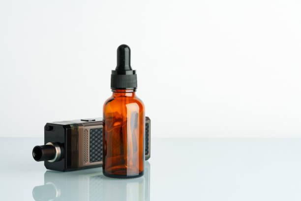 istock Electronic cigarette with smoking liquid bottle on white background 1712700783
