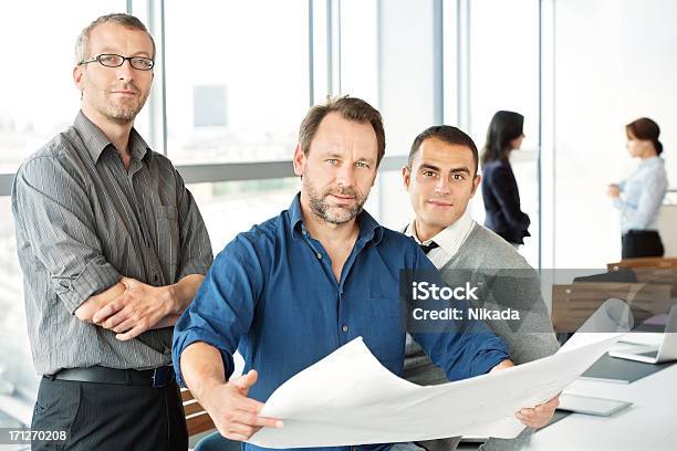 Engineers With Blueprint Stock Photo - Download Image Now - 30-39 Years, Adult, Adults Only