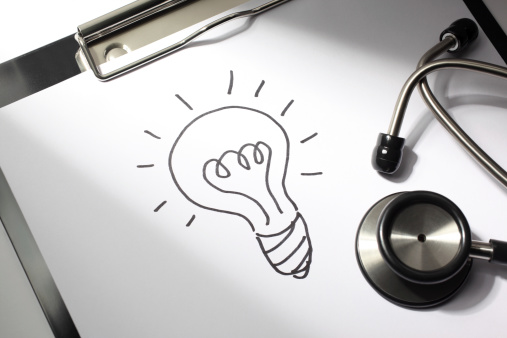 Healthcare concept. Lightbulb drawn on a doctor's clipboard with stethoscope.