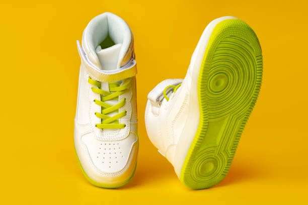 istock White sneakers with yellow neon laces on yellow background 1712705066