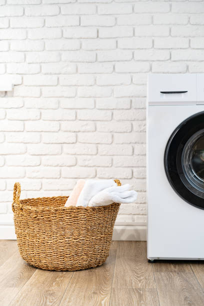 istock Washing machine and basket in a laundry room 1712709253