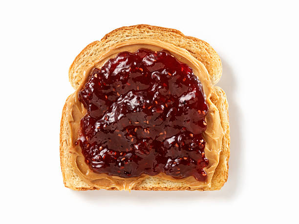 Peanut Butter and Jam on Toast Peanut Butter and Raspberry Jam on Toast with Natural Drop Shadow- Photographed on Hasselblad H3D2-39mb Camera peanut butter and jelly sandwich stock pictures, royalty-free photos & images