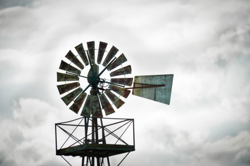 An old agricultural windpump against a stormy sky.Click on the banner below for more photos of agricultural windmills: