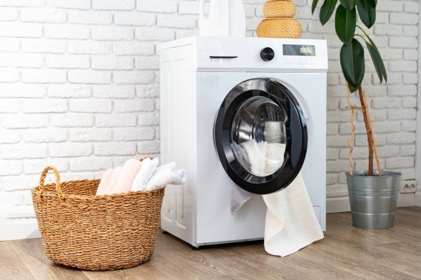 istock Washing machine and basket in a laundry room 1712714002