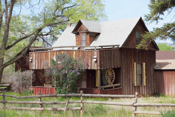 historic home in Torrey Utah below  trees with fence
