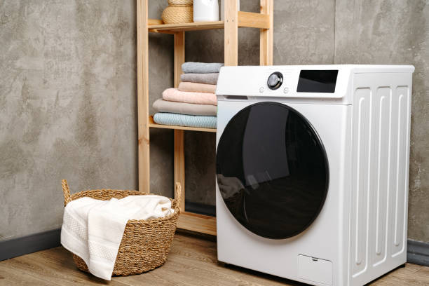 istock Laundry room interior with washing machine near gray grunge wall 1712718837