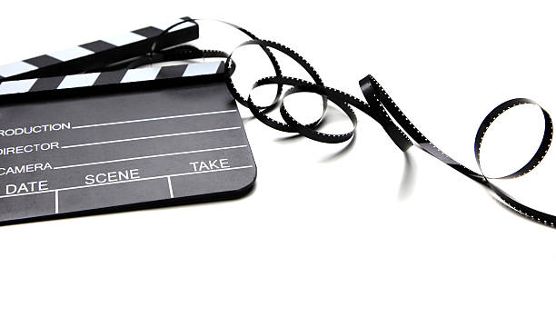 istock A movie clapper board and film on white background 171272231