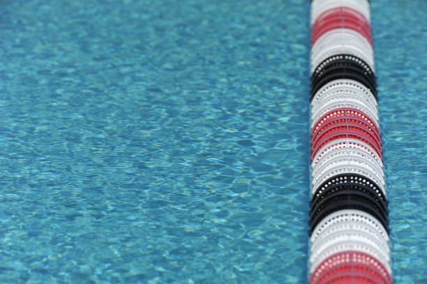 sport swimming pool sport swimming pool of 25 meters with lanes and blue water - ready for competition swimming pool lane ropes stock pictures, royalty-free photos & images