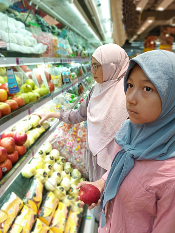 Indonesian hijab women in routine daily activities which is shopping at the supermarket.
