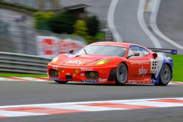 Ferrari F430 GT race car at the race track "Spa, Belgium - July 25, 2009: CRS Racing Ferrari F430 GT2 driving through the Eau Rouge corner at Spa Francorchamps during the 2009 edition of the 24 Hours of Spa race." ferrari ferrari f430 italian culture action stock pictures, royalty-free photos & images