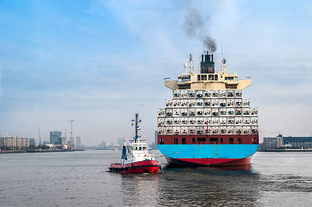 Tugboat and cargo ship stock photo