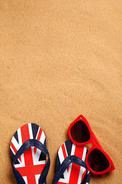 istock Sandals and sunglasses on the sand 171272812