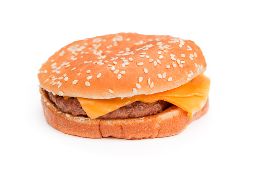 Cheeseburger. Studio isolated on white with light shadow. Shallow depth of field.