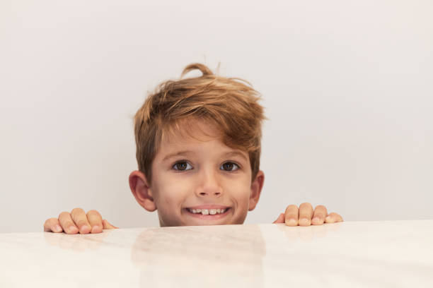 Portrait of a beautiful boy peeking.