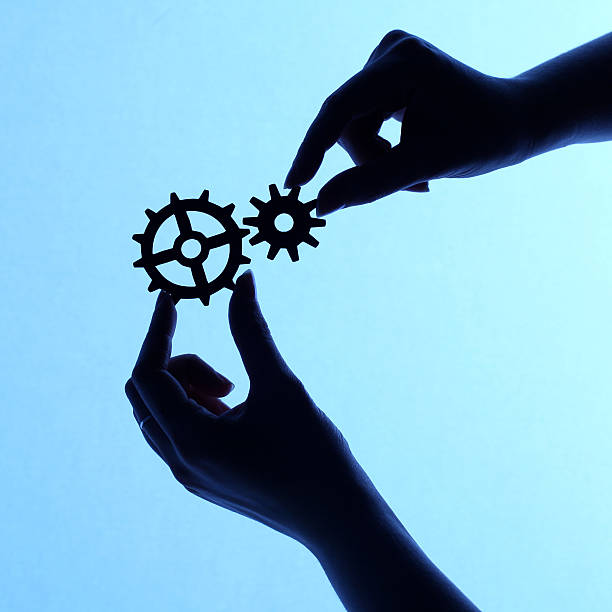 istock Silhouette of hands holding cogs and gears 171273233