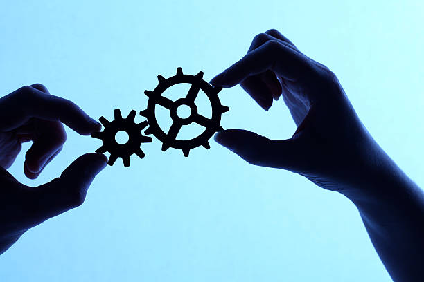 istock Silhouette of hands holding cogs and gears 171273287