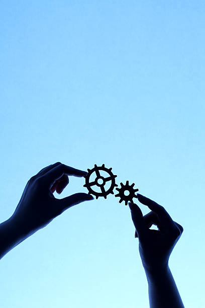istock Silhouette of hands holding cogs and gears 171273313